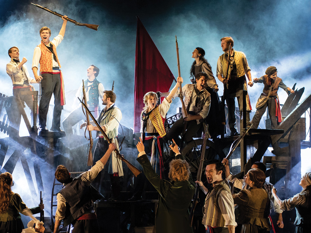 The cast of Les Miserables on stage at the Sondheim Theatre