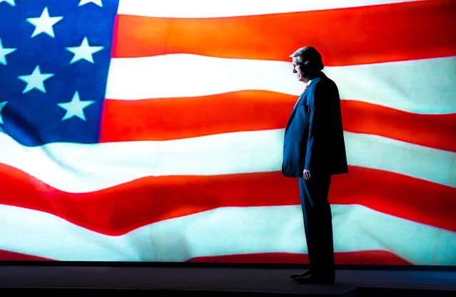 Donald Trump (Bertie Carvel) in front of the US flag - The 47th at the Old Vic Theatre