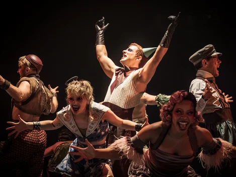 Emcee (Skylar Astin) and the cast of Cabaret