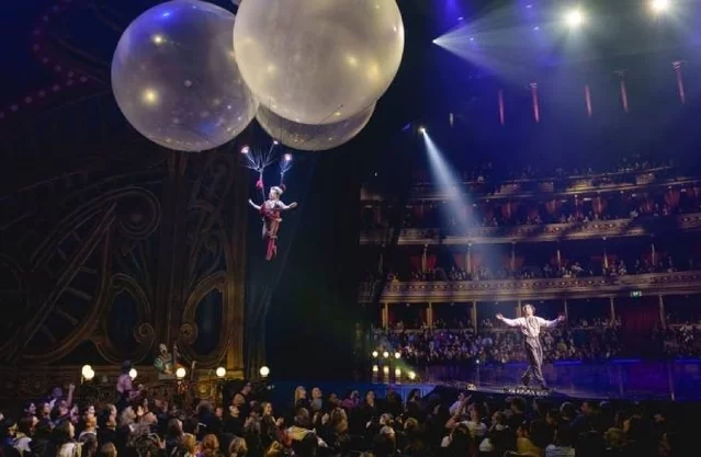 Performers flying over the audience at Cirque du Soleil: Corteo