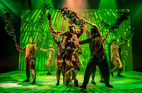 The company of Life of Pi, performing with an orangutan puppet, at Wyndham's Theatre