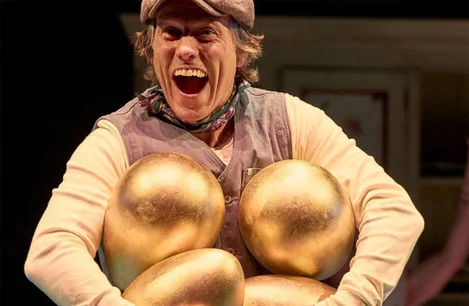 John Bishop with an armful of golden eggs in Mother Goose at the Duke of York's Theatre