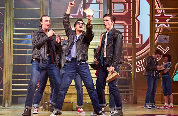 Paul French (Kenickie), Damon Gould (Sonny) and Noah Harrison (Roger) in Grease at the Dominion Theatre