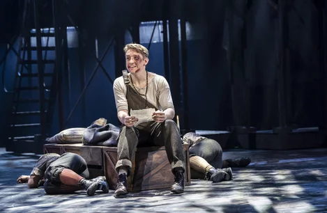 Matthew Duckett as Crutchie in Newsies