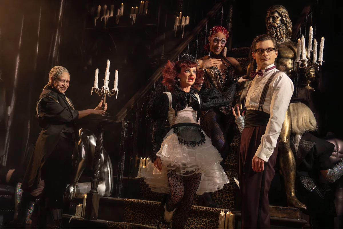 Riff Raff (Amber Gray), Magenta (Juliette Lewis), and Columbia (Michaela Jaé Rodriguez) greet Bard (Andrew Durand) in Rocky Horror