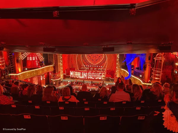 A photo from the Royal Circle for Moulin Rouge the musical, showing a restricted view due to the overhang above. 